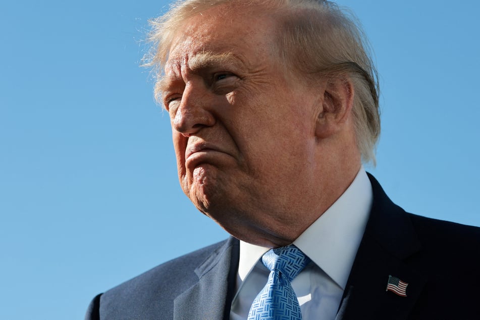 President Donald Trump speaks to reporters near Air Force One. The president is offering a $1 million bounty to those who provide voter fraud tips that lead to an arrest and conviction. 