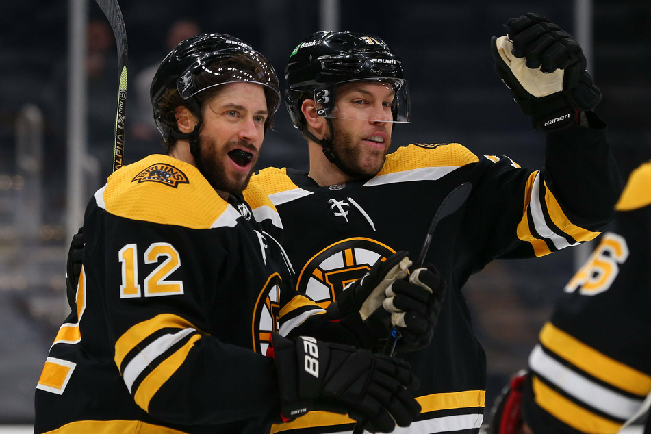 Bruins right wing Craig Smith (l) and Boston Bruins left wing Taylor Hall (r) celebrate a goal during their 6-2 win over the Sabres on Saturday