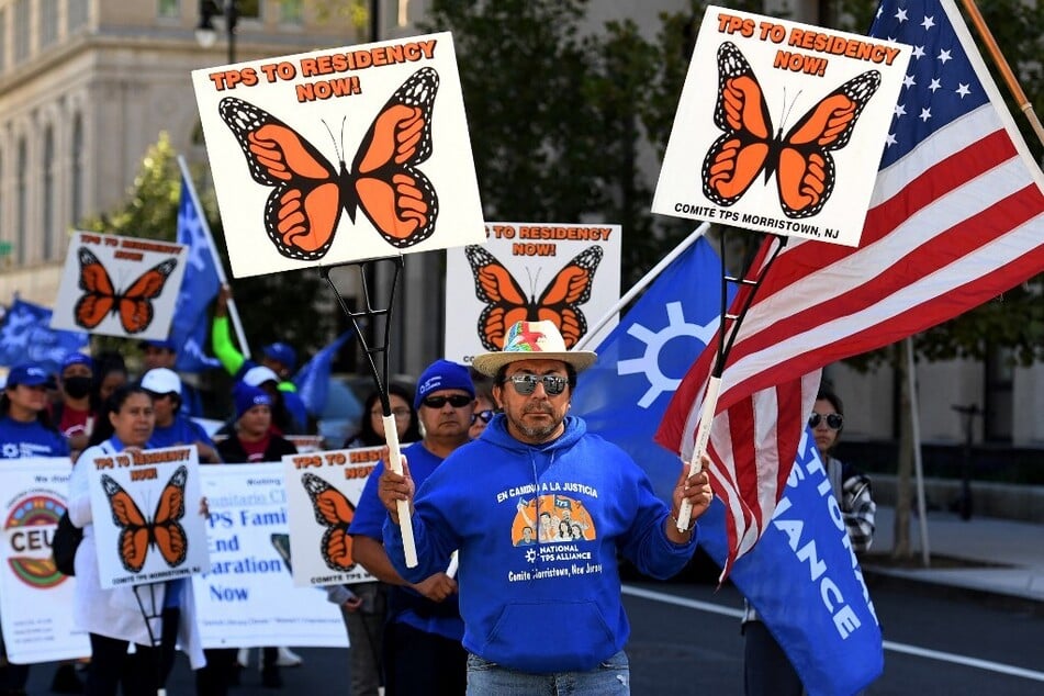 Supporters and allies of the National TPS Alliance march for residency protections in Washington DC.