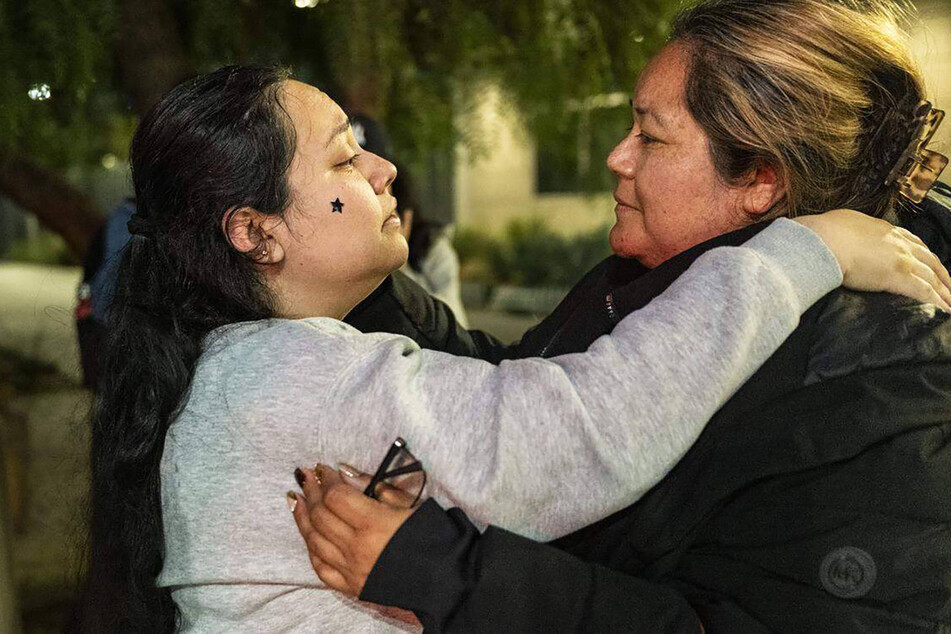 Damaris Bello (l.) embraces her mother, Maria de Jesus Estrada Juarez, after the latter exits the San Ysidro pedestrian crossing on March 30, 2026.