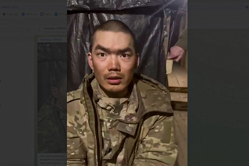 This handout video grab published on the official Telegram channel of Ukrainian President Volodymyr Zelensky on Tuesday shows, according to the Ukrainian president, one of two Chinese soldiers he said were captured by Ukrainian forces in the Donetsk region.