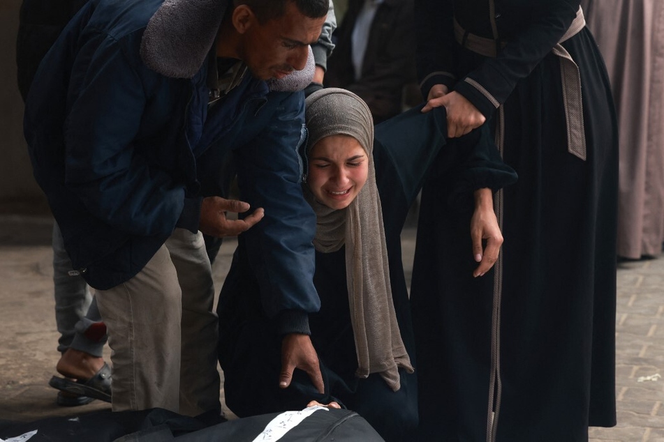 Palestinians mourn over the bodies of relatives killed in Israeli bombardment, at the al-Najar hospital in Rafah, in the southern Gaza Strip.