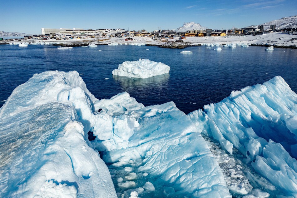 This aerial view shows icebergs floating in the waters beaten down by the sun off Nuuk, Greenland, on March 11, 2025.