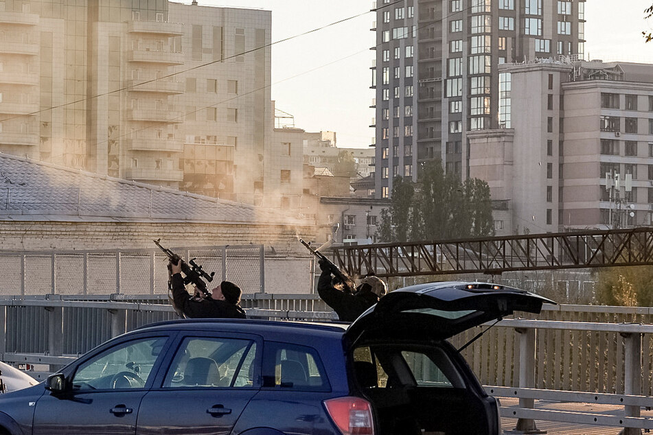 Ukrainian forces shoot at Russian drones flying over Kyiv on Monday.