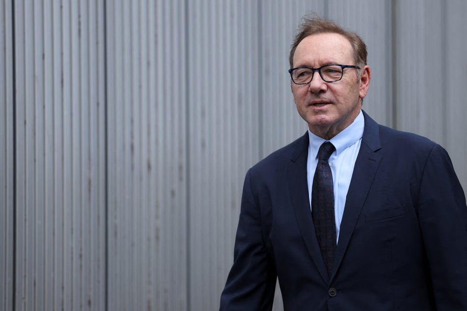 Kevin Spacey walks outside London's Southwark Crown Court as his trial over charges related to allegations of sex offenses continues.