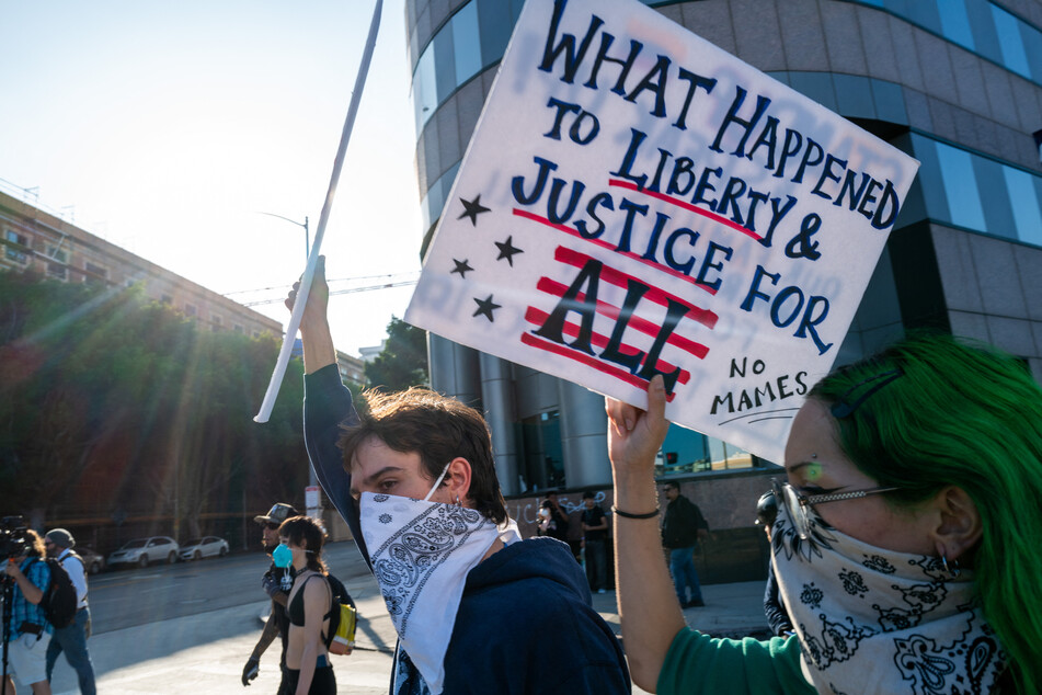 Protesters march through downtown Los Angeles, California, in demonstrations against the Trump administration's immigration raids.