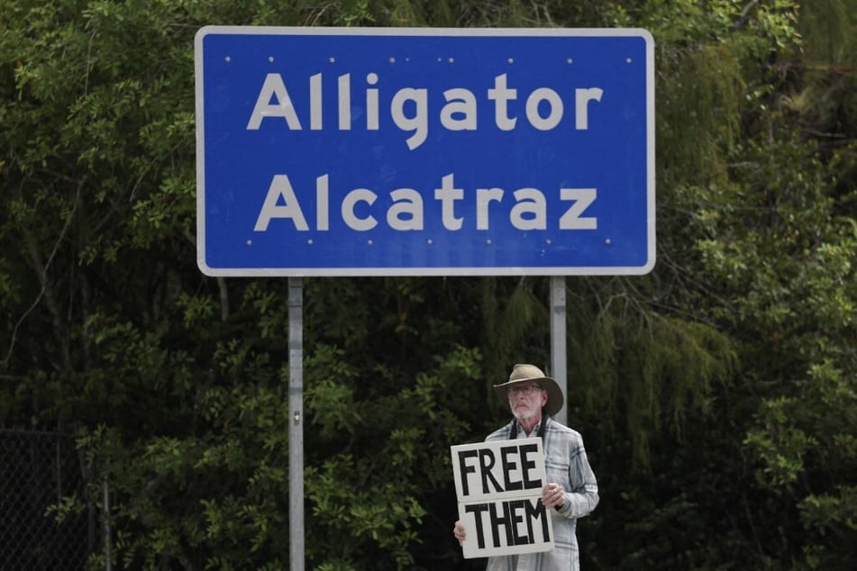A protester at the entrance to "Alligator Alcatraz" at the Dade-Collier Training and Transition Airport on August 22, 2025 in Ochopee, Florida.