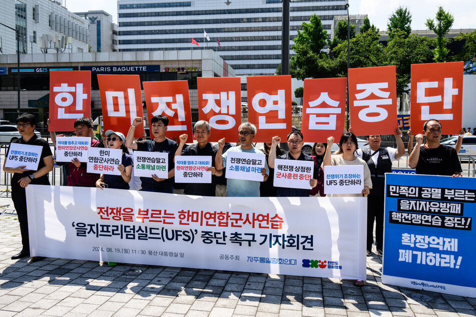 South Korean protesters held banners that collectively read "Stop the military exercise between the US and South Korea" during a rally Monday opposing the joint drills.