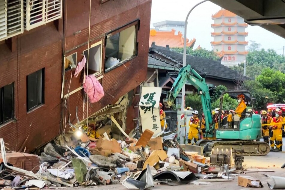 This frame grab from AFPTV video taken on April 3, 2024, shows rescue workers searching for survivors at the damaged Uranus Building in Hualien, after a major earthquake hit Taiwan's east.