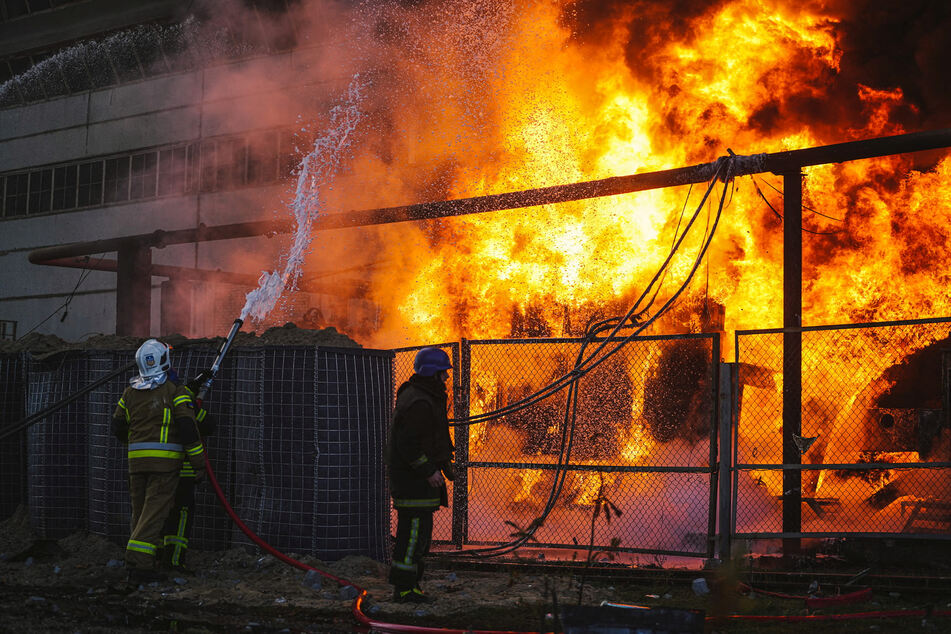 Firefighters work to put out a fire in a thermal power plant, damaged by a Russian missile strike in Kyiv on October 18.