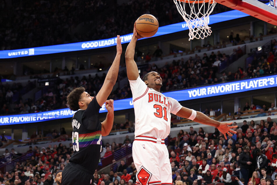 Jaden Ivey of the Chicago Bulls attempts a dunk against Cameron Johnson of the Denver Nuggets during the second quarter at the United Center on February 7, 2026.