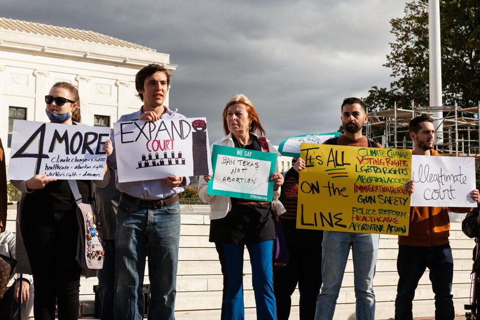 Protesters rallied outside the Supreme Court demanding four new seats be added.