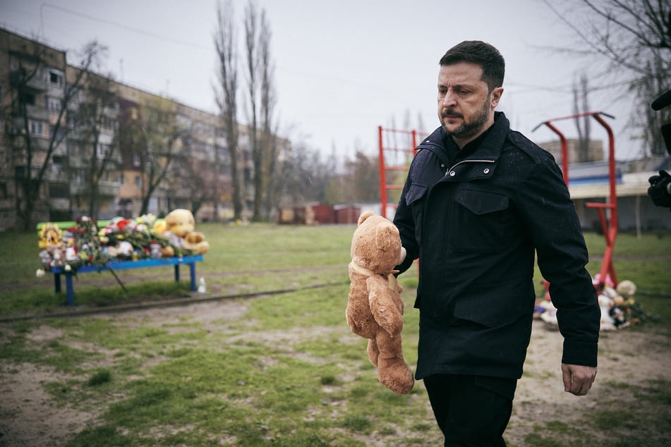 This handout photograph taken and released by the Ukrainian Presidential Press Service on April 11, 2025, shows Ukraine's President Volodymyr Zelensky honoring the memory of those killed in a Russian missile strike on Kryvyi Rigon, amid the Russian invasion of Ukraine.
