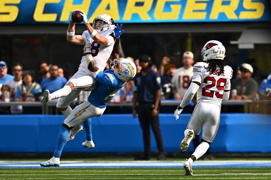 Arizona Cardinals safety Andrew Wingard makes an interception in front of Los Angeles Chargers wide receiver Derius Davis during the fourth quarter at SoFi Stadium.