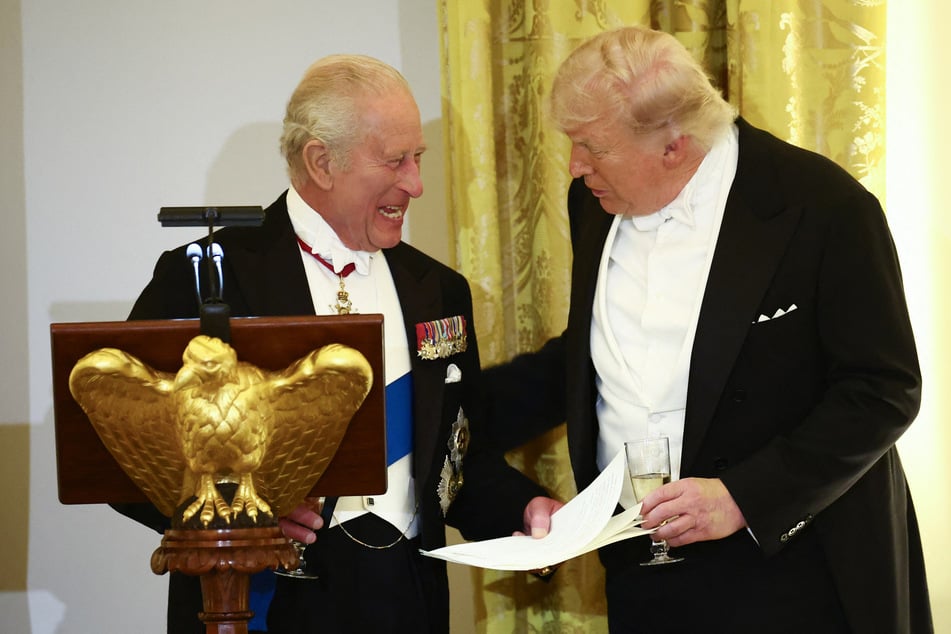 US President Donald Trump (r.) and Britain's King Charles III smile as they talk during a State Dinner in the East Room of the White House on April 28, 2026.