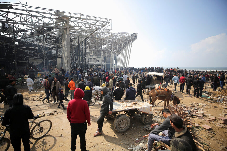 Israeli troops opened fire on crowds of Palestinians who surrounded aid trucks that made it through to Gaza City, reportedly killing scores.