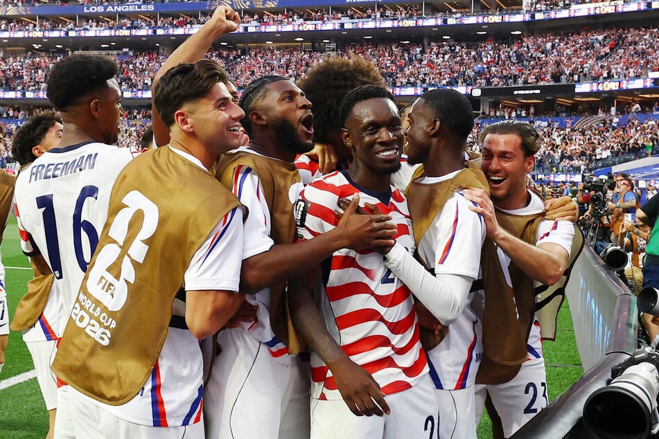 Folarin Balogun celebrates scoring the USMNT's third goal against Paraguay with teammates on June 12, 2026.