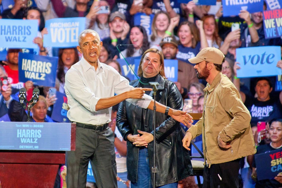Former President Barack Obama (l.) and rapper Eminem (r.) during a rally for Kamala Harris at the Huntington Place convention center in Detroit, Michigan on October 22, 2024.