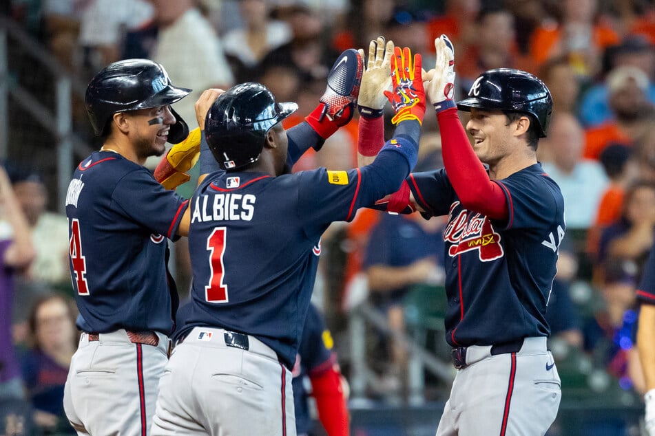 Mauricio Dubon (l.), Ozzie Albies (c.), and Mike Yastrzemski (r.) of the Atlanta Braves celebrate a three-run home run during the sixth inning against the Houston Astros at Daikin Park on September 20, 2026.