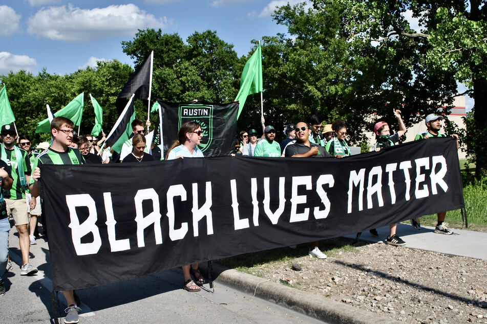 During the march to the stadium, several fans led the way while carrying a Black Lives Matter banner.