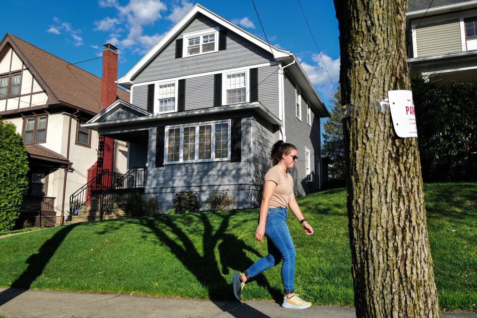 A pedestrian walks past the house where President Joe Biden grew up until he was ten years old in Scranton, Pennsylvania on Monday.