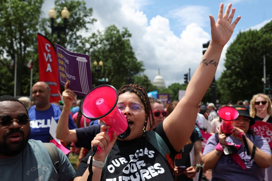 Abortion rights demonstrators rally one year after the Supreme Court overturned the landmark Roe v. Wade abortion decision.