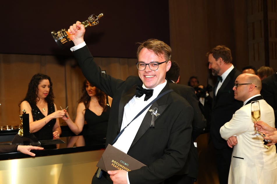 Russian teacher Pavel Talankin hoists his Oscar for Best Documentary Feature Film for "Mr. Nobody Against Putin" at the 98th Annual Academy Awards Governors Ball on March 15, 2026.