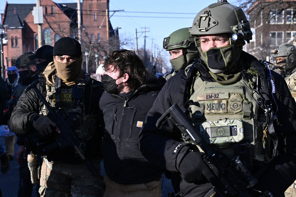 Masked ICE agents filmed pulling guns on woman in shocking Minnesota footage