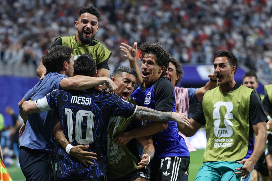 Argentina's forward #10 Lionel Messi celebrates with teammates defender #25 Facundo Medina and forward #17 Giuliano Simeone his team's second goal scored by Argentina's forward #22 Lautaro Martinez (out of frame) during the 2026 World Cup soccer tournament semi-final match between England and Argentina at the Atlanta Stadium in Atlanta on Wednesday.