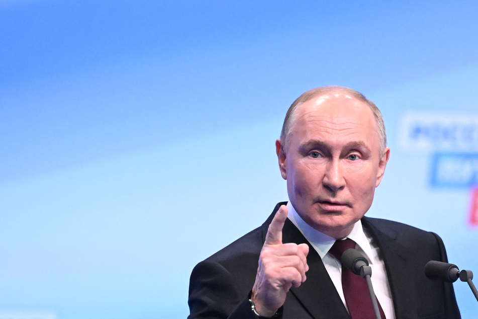 Putin celebrates easy presidential election win with rare reference to Navalny