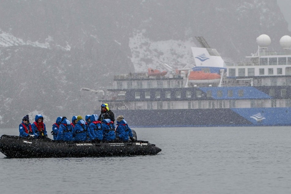 Tourists visit Whaler’s Bay at Deception Island in the western Antarctic Peninsula.