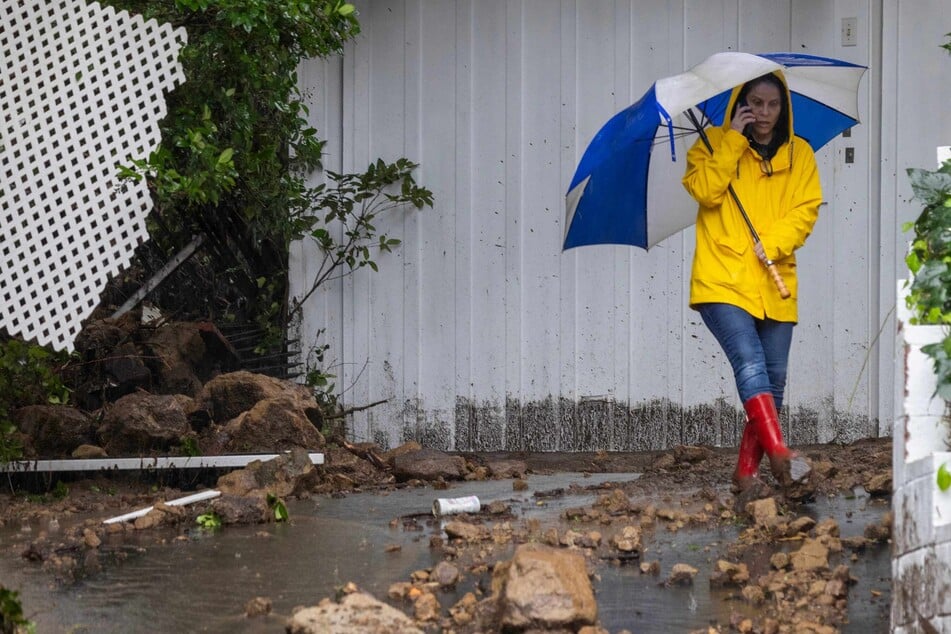 Los Angelenos surveyed damage by a landslide in a hillside residential neighborhood as the biggest storm of the season inundated the Studio City section of LA on Monday, amid a state of emergency.