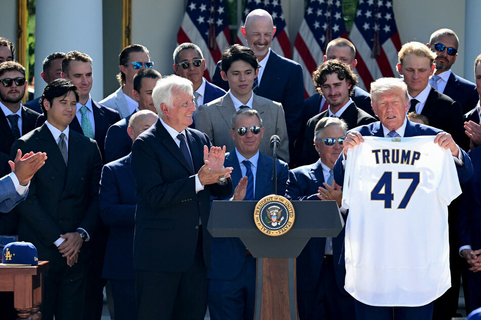 President Donald Trump holds a Los Angeles Dodgers jersey with his name and the number 47 as Dodgers owner Mark Walter (L) applauds during a ceremony to honor the 2025 World Series champions in the Rose Garden at the White House in Washington, DC, on Thursday.