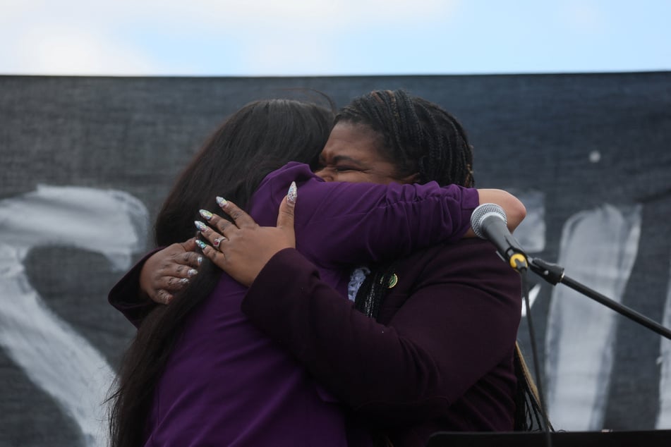 Tlaib embraces fellow progressive Representative Cori Bush at a protest demanding a ceasefire in Israel's war on Gaza.