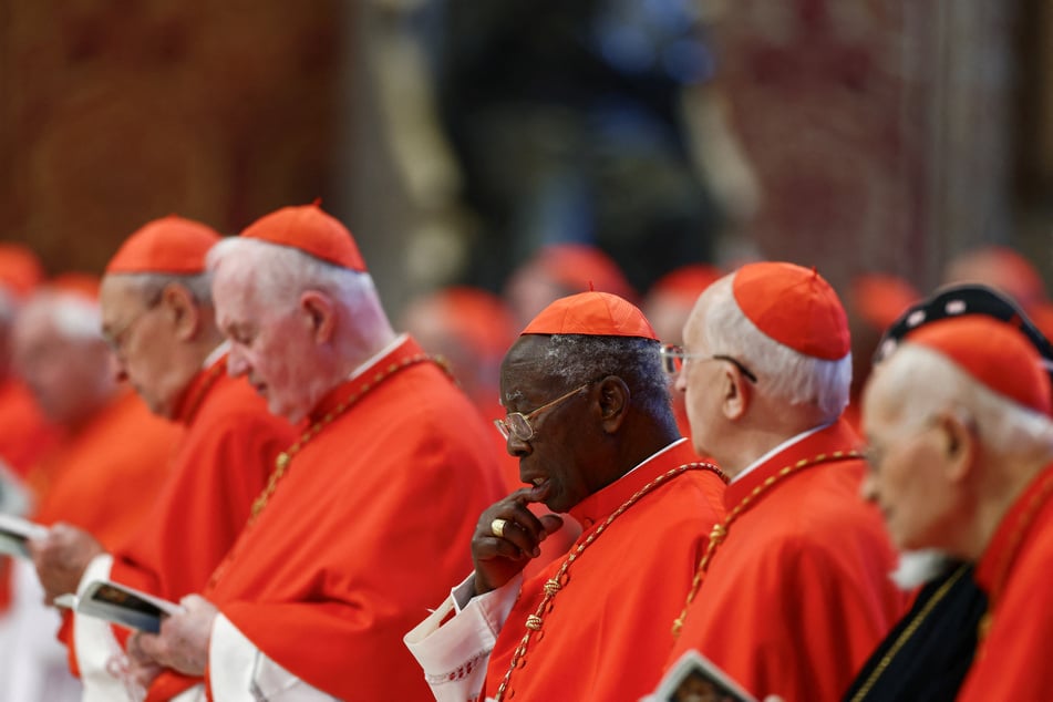Cardinals stand, on the day of the translation of Pope Francis' body, in St. Peter's Basilica at the Vatican on April 23, 2025.