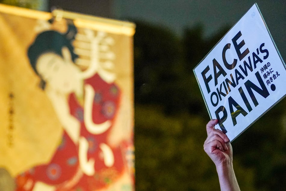 A demonstrator protests against the killing of a woman in Okinawa allegedly committed by a US Marine, in front of the US Embassy in Tokyo on Tuesday. The case has led to an alcohol ban and 30-day curfew for US troops.