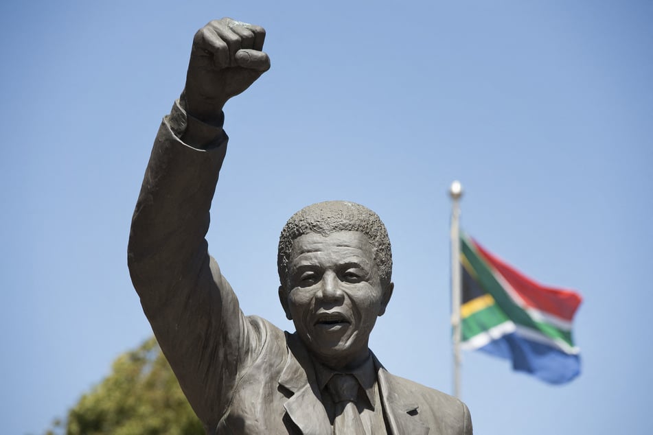 A statue of Nelson Mandela depicting him walking to freedom with a South African flag in the background stands in front of the entrance of the Drakenstein Prison, previously called Victor Verster Prison, in Paarl on January 23, 2020.