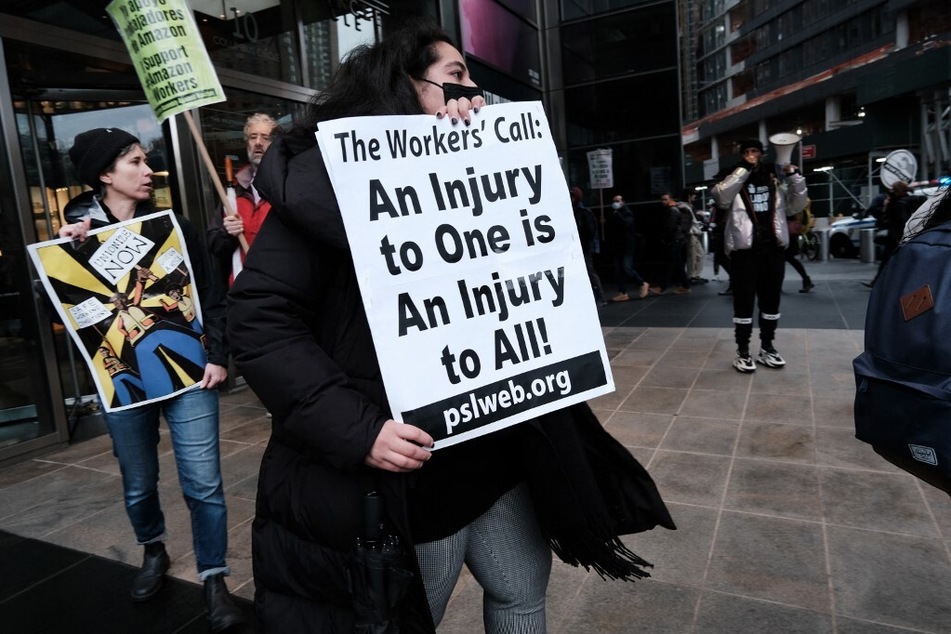 Members and supporters of the Amazon Labor Union protest outside of the New York Times DealBook Summit as Amazon CEO Andy Jassy appears to speak November 30, 2022.