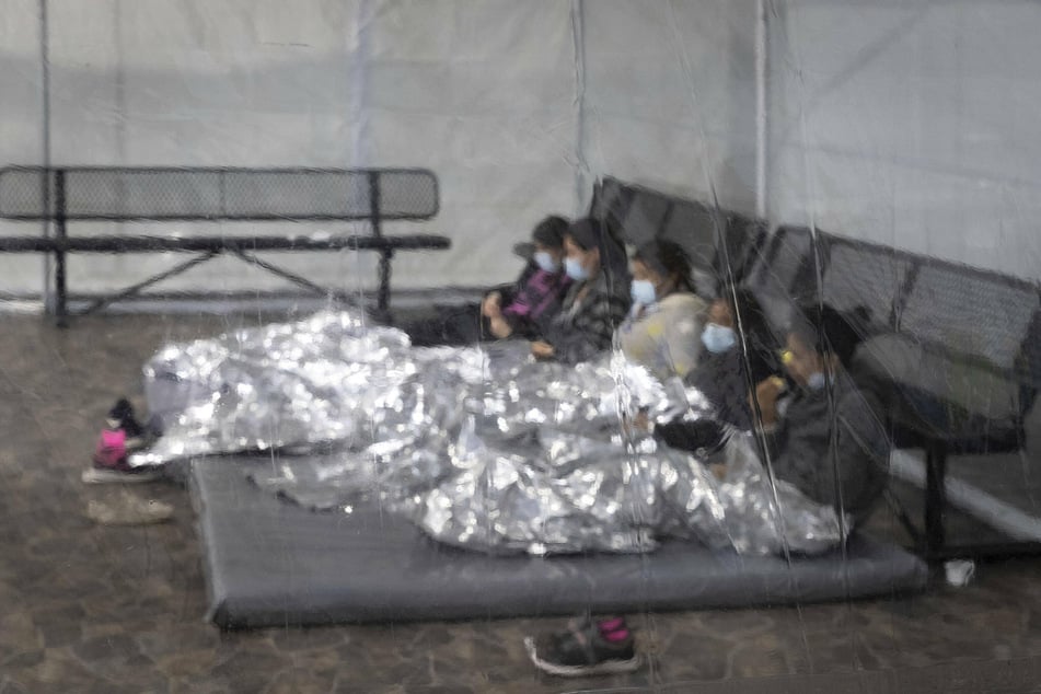 Children and families wait to be processed at a US Customs and Border Patrol center.