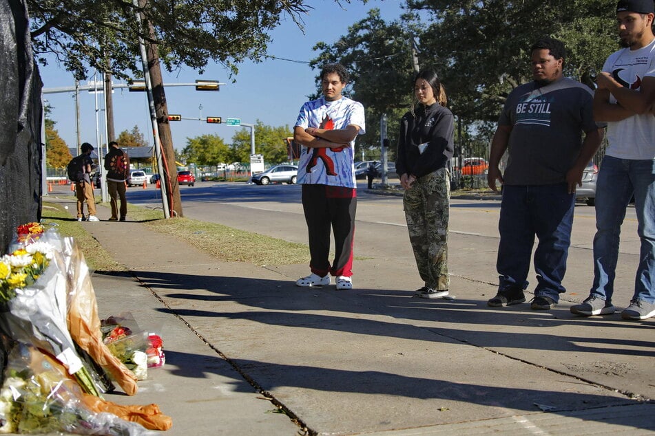 Mourners pay respect outside the concert venue, where a makeshift memorial has been set up.