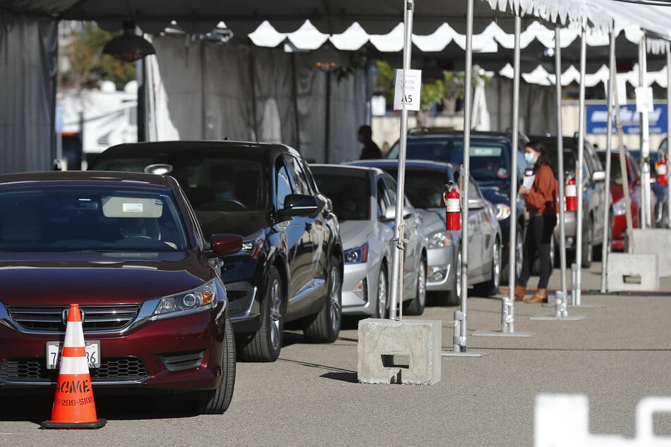 Health care workers line up to get a Covid-19 vaccine at a Vaccination Super Station which opened at Tailgate Park in San Diego.