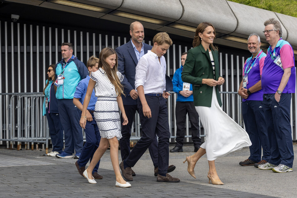 Prince William (c) and Kate Middleton (r) brought all three of their children to the event.