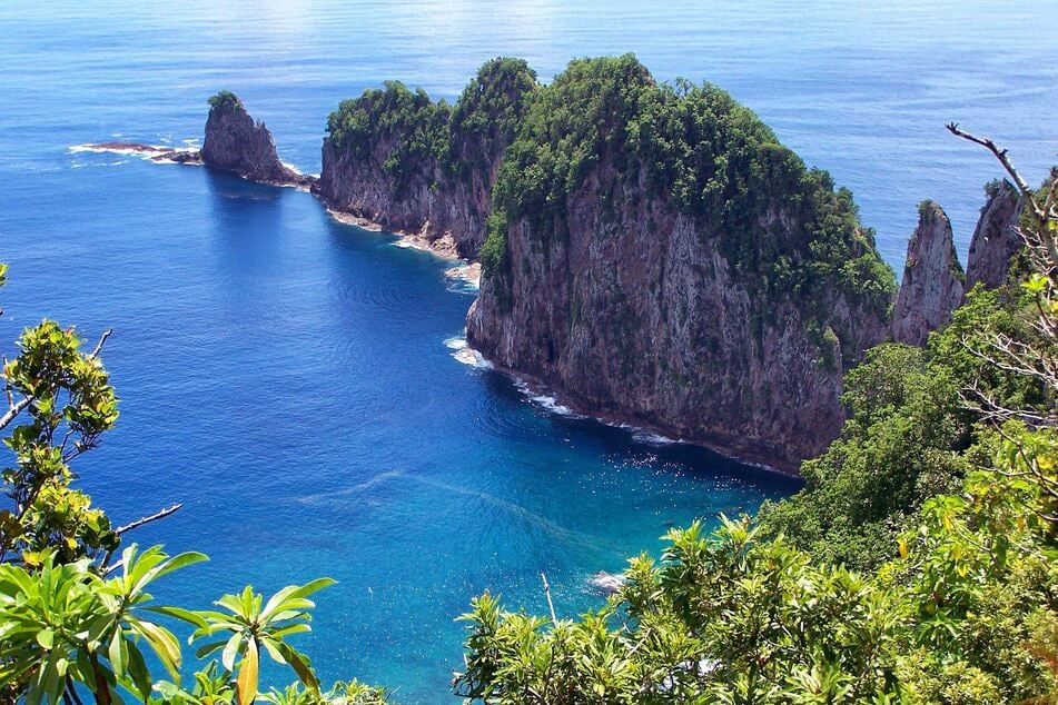 Tropical island cliffs are pictured in American Samoa, where the Trump administration announced it has finalized a deep-sea mining auction.