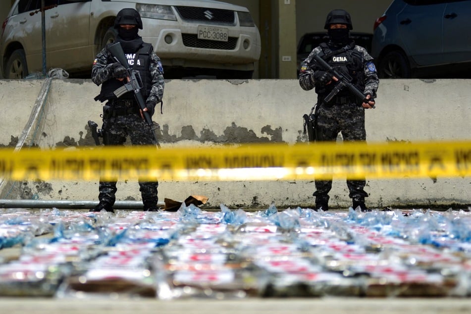 A photo from Ecuador's Armed Forces press office shows soldiers guarding packs containing 3.7k tons of cocaine hydrochloride, seized in April 2022 after the capture of a semi-submersible. Ecuador says the US has supplied it with powerful Reaper drones to combat drug trafficking.