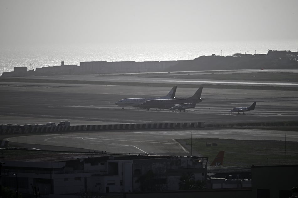 Aircraft are seen on the runway at Simon Bolivar International Airport in Maiquetia, La Guaira state, Venezuela, on Thursday, following earthquakes.