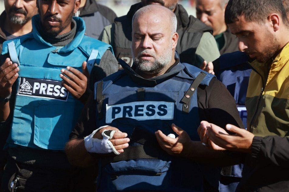 Al Jazeera's bureau chief in Gaza, Wael Al-Dahdouh, prays during the funeral of his son Hamza Wael Dahdouh, a journalist with the Al Jazeera television network killed in an Israeli airstrike in Rafah.