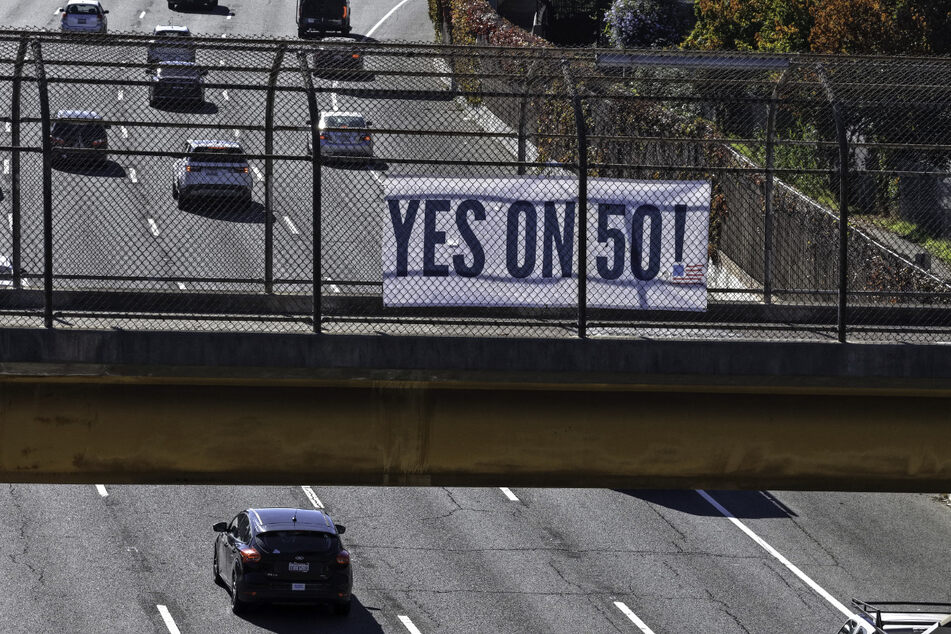A banner over Highway 101 in San Rafael reads "Yes On Prop 50," in support of a California redistricting plan aimed at countering Republican gerrymandering.