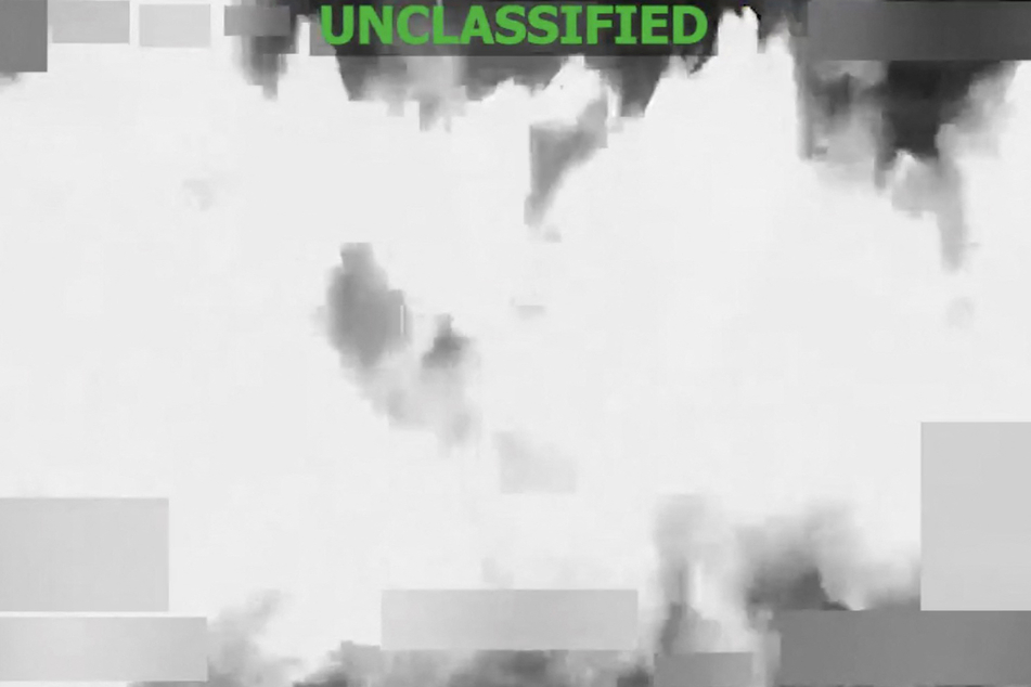 A screen grab from a video posted on the X account of US Southern Command shows a strike at the direction of Defense Secretary Pete Hegseth on a vessel in international waters on January 23, 2026.