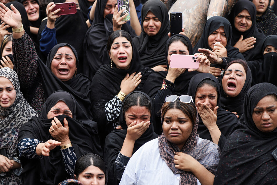 Mourners cry during the funeral of children killed in a strike on a primary school in Minab, Iran, on March 3, 2026.