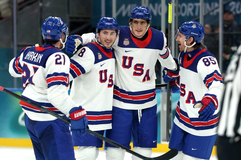 Tage Thompson celebrates scoring the US' fourth goal with teammates during the Group C preliminary round against Germany at the Milano Santagiulia Ice Hockey Arena on February 15, 2026.